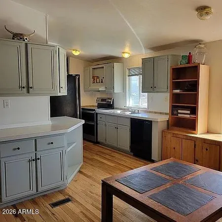 a kitchen with a sink a refrigerator a stove and a cabinets