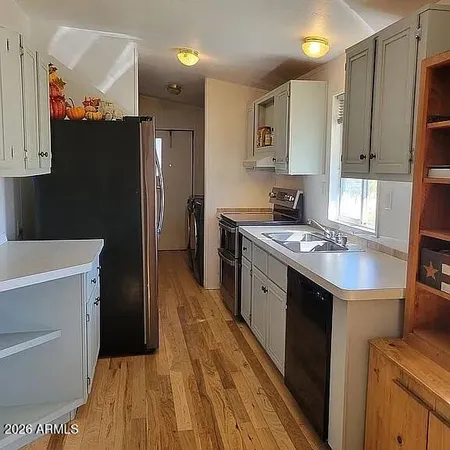 a kitchen with stainless steel appliances granite countertop a sink stove and cabinets