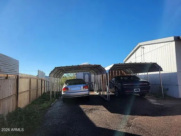 a view of a roof deck with table and chairs under an umbrella