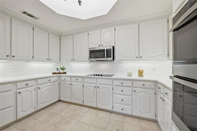 a kitchen with white cabinets