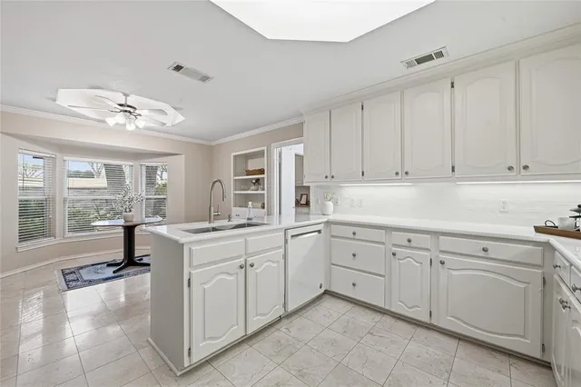 a kitchen with a sink and cabinets