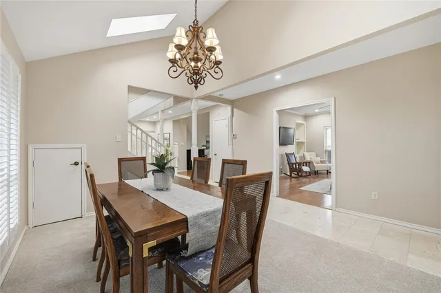 a view of a dining room with furniture and chandelier