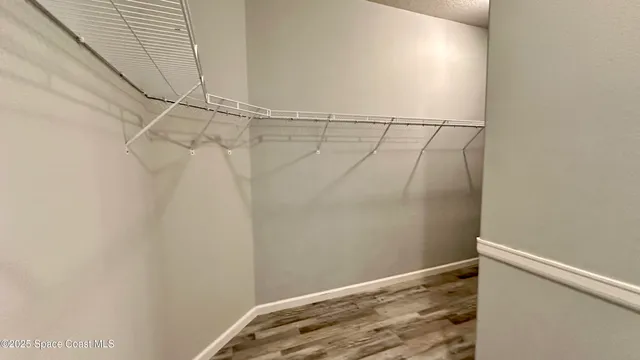 a view of a livingroom with a window and a ceiling fan