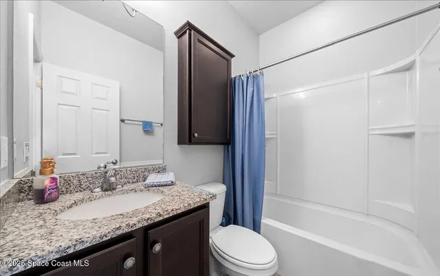 an empty room with wooden floor and entrance