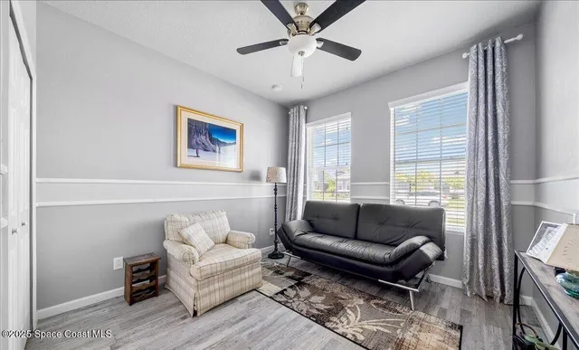 a living room with stainless steel appliances kitchen island furniture and wooden floor