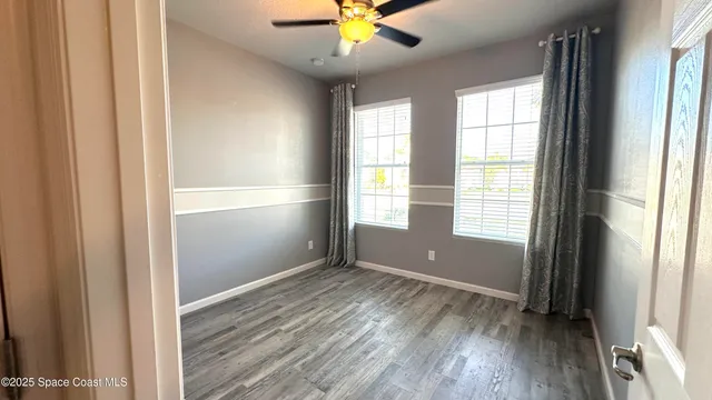 an empty room with wooden floor and closet