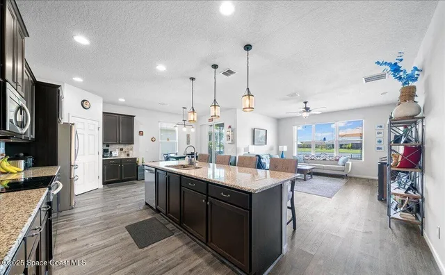 a kitchen with sink stove and cabinets