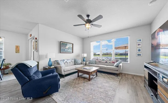 a living room with furniture and a large window