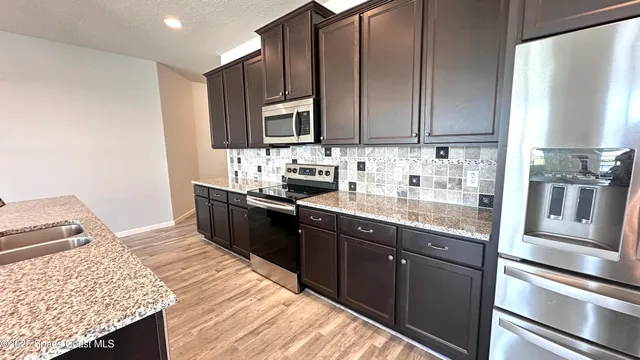 a large kitchen with stainless steel appliances kitchen island a large island in the center