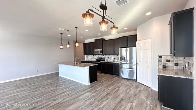a view of living room with furniture and a mirror