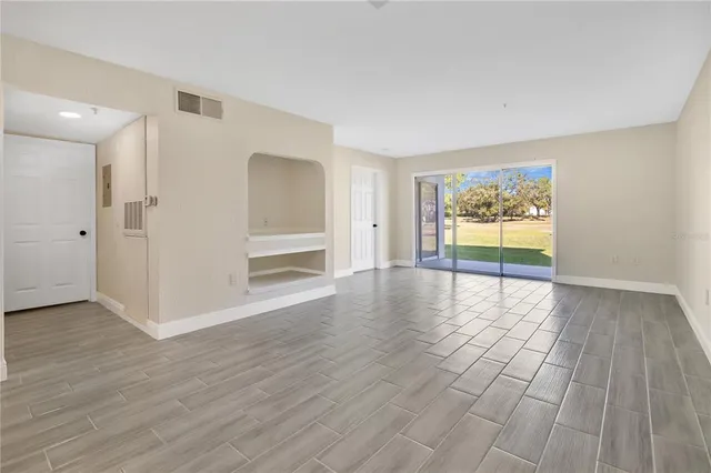 a view of an empty room with glass door