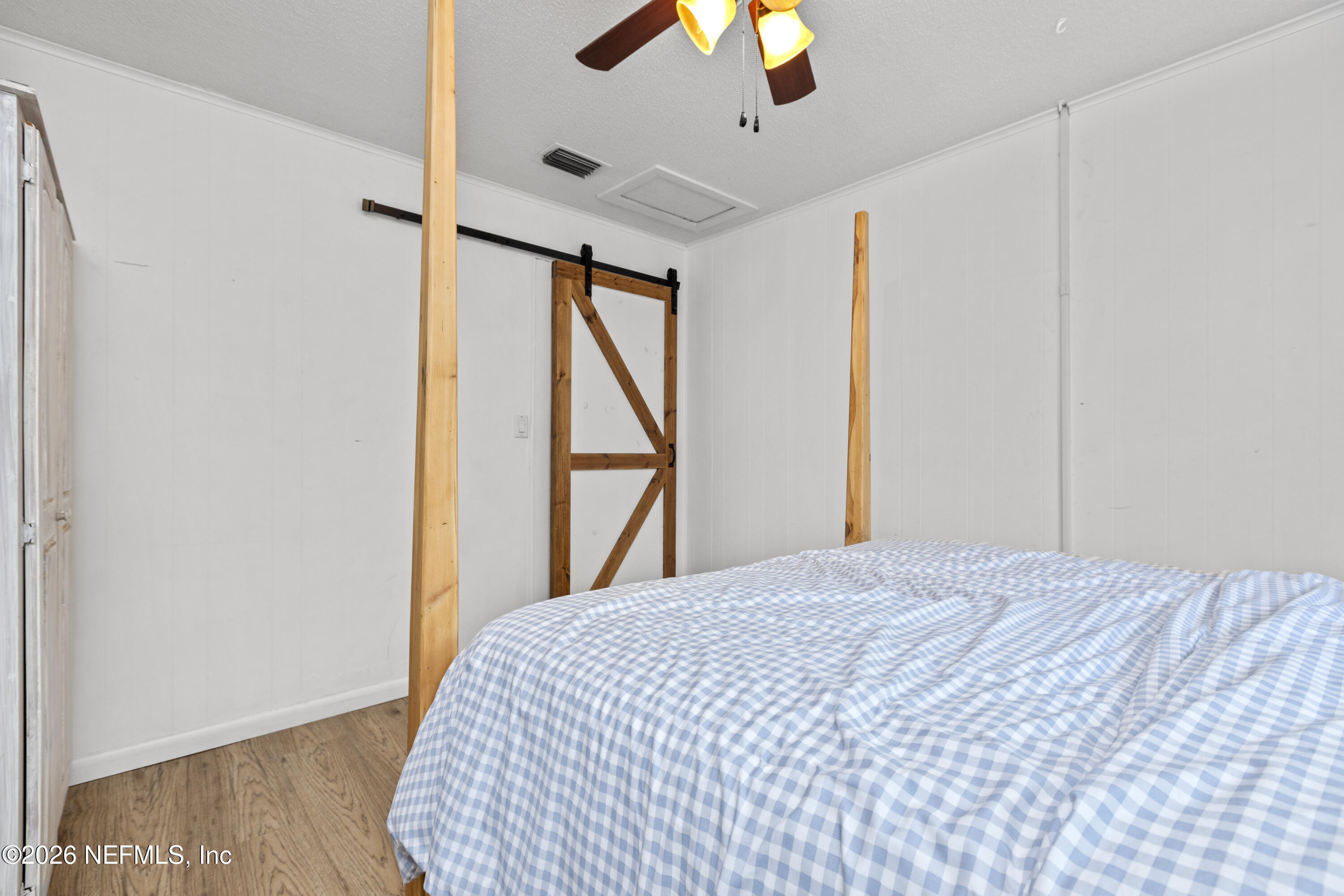155 Roddy Road Palatka, FL 32177 - Photo 13 of 41 a bedroom with a large bed and a chandelier