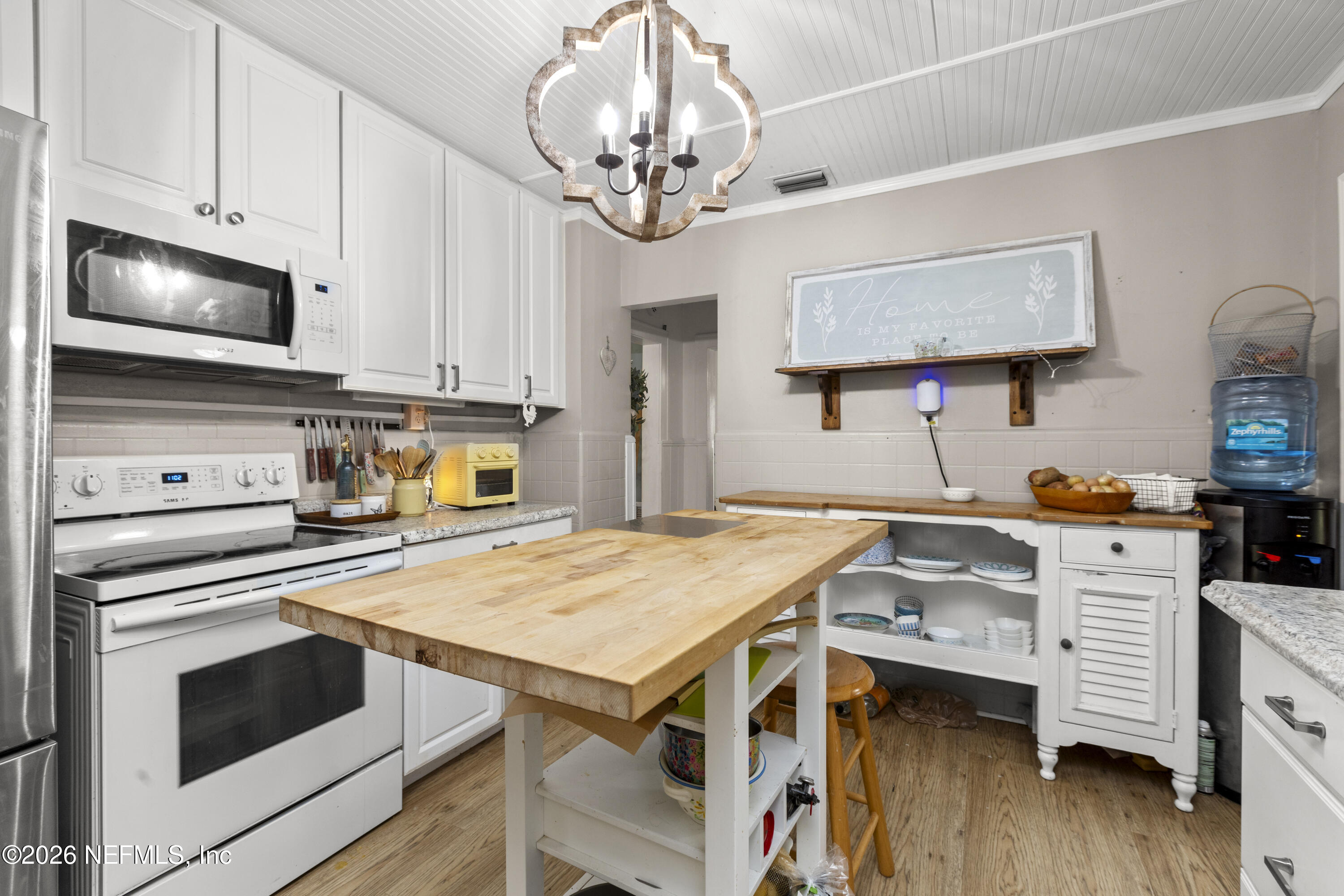 155 Roddy Road Palatka, FL 32177 - Photo 16 of 41 a kitchen with a stove cabinets and wooden floor