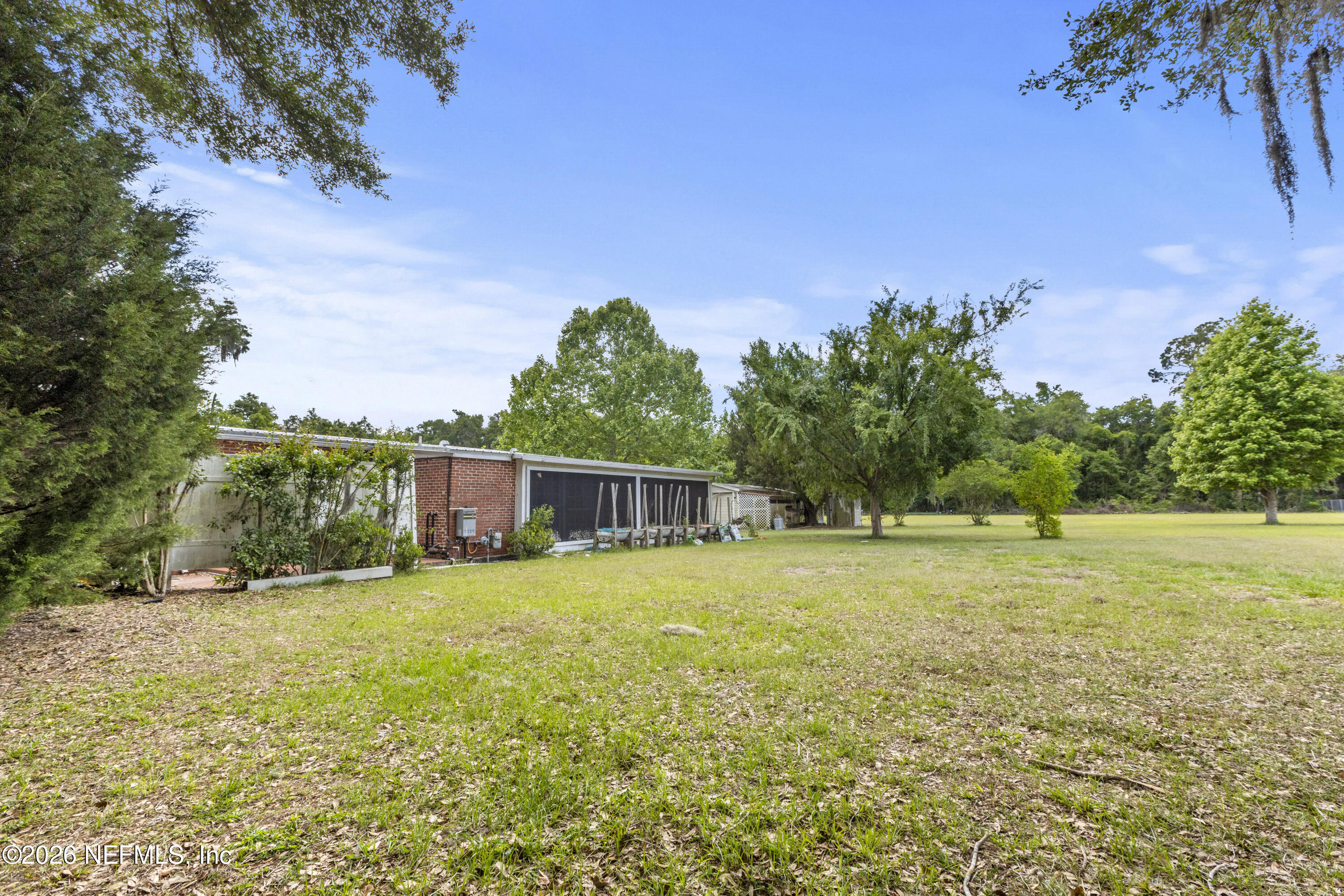 155 Roddy Road Palatka, FL 32177 - Photo 29 of 41 a backyard of a house with plants and large trees