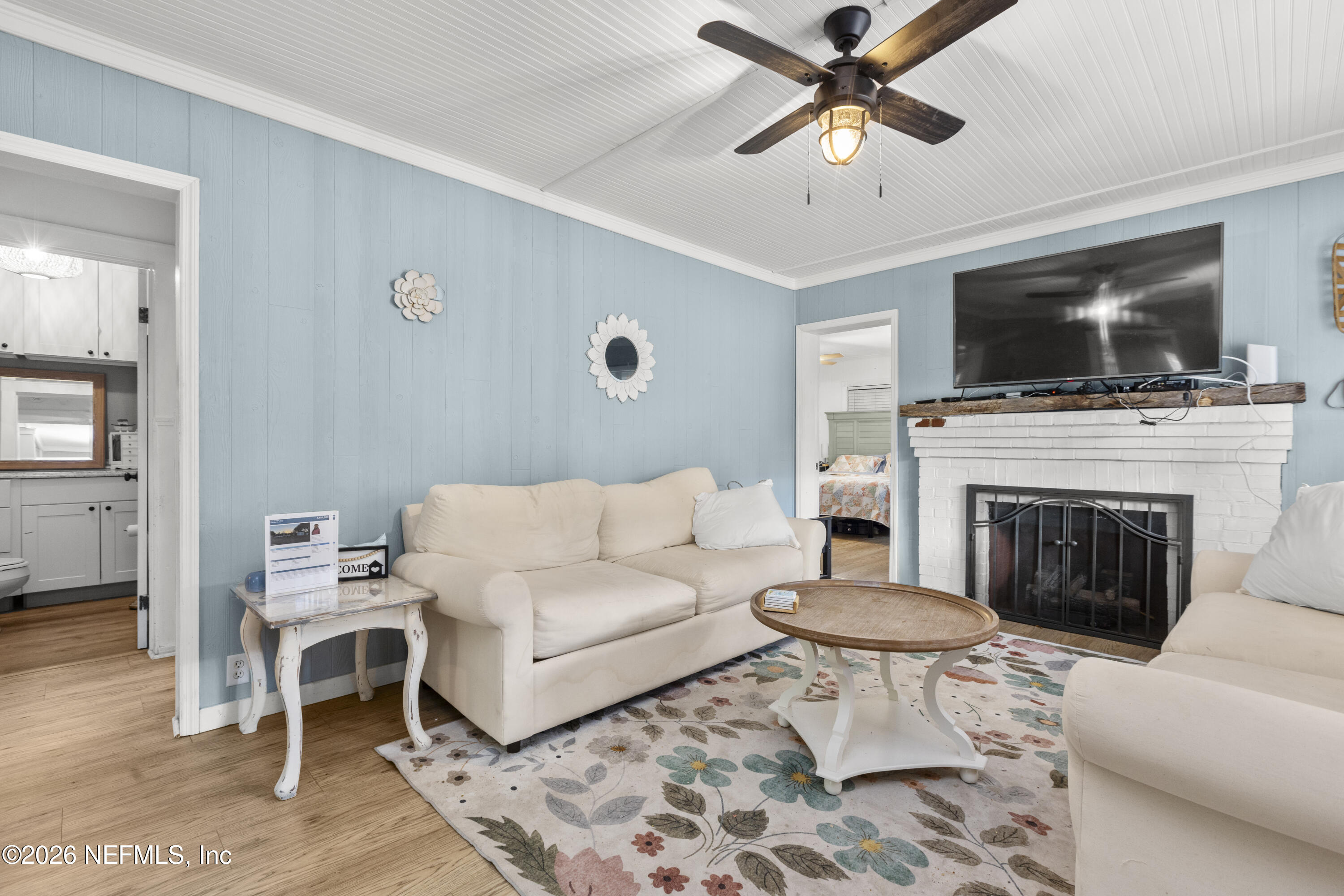 155 Roddy Road Palatka, FL 32177 - Photo 4 of 41 a living room with furniture a flat screen tv and a fireplace