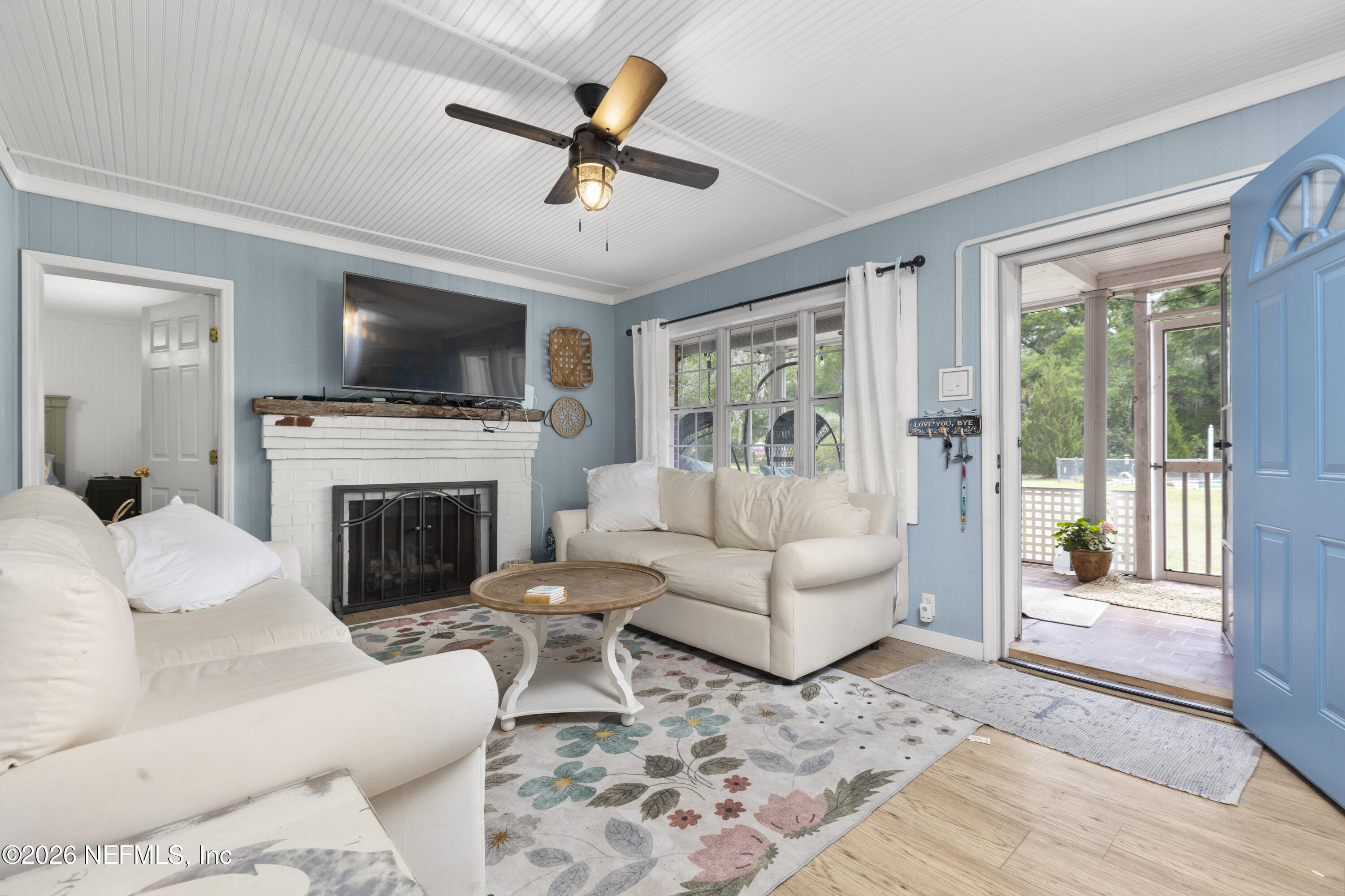 155 Roddy Road Palatka, FL 32177 - Photo 7 of 41 a living room with furniture a flat screen tv and a fireplace