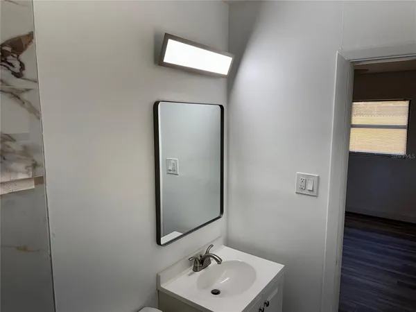 a white toilet sitting next to a bath tub