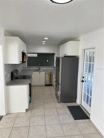 a kitchen with granite countertop a stove and a microwave