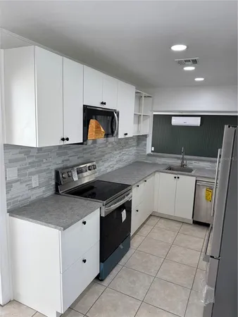 a view living room with a sink and cabinets
