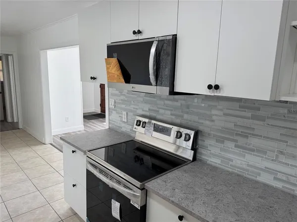 a view of a kitchen with refrigerator and table