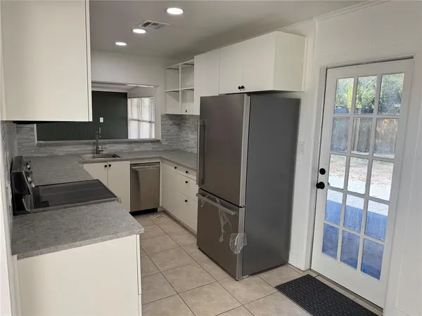 a kitchen with stainless steel appliances granite countertop a sink and a stove