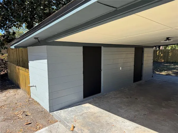 a backyard of a house with table and chairs