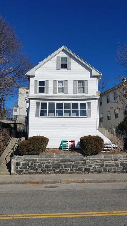 69 East Central Street Worcester, MA 01605 - Photo 1 of 12 a front view of a house with a parked car