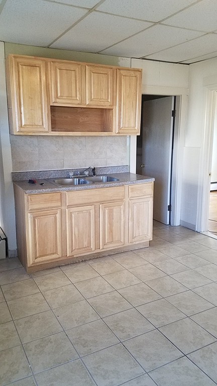 69 East Central Street Worcester, MA 01605 - Photo 5 of 12 a kitchen with cabinets and window