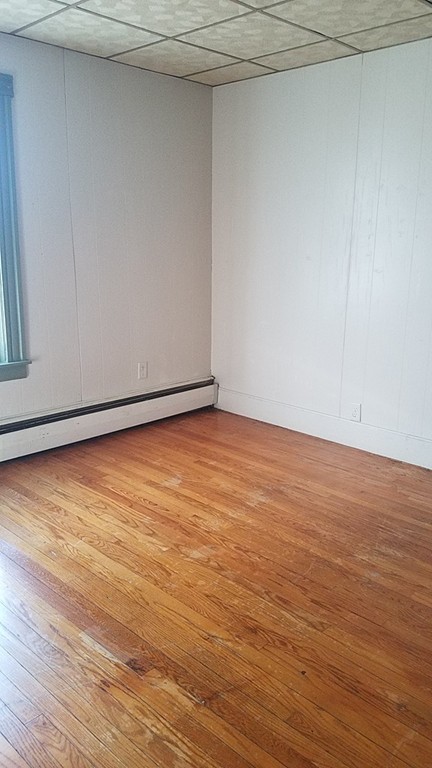 69 East Central Street Worcester, MA 01605 - Photo 8 of 12 a view of an empty room with wooden floor