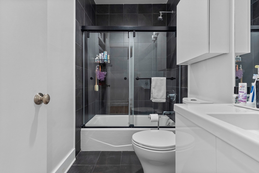 113 Chandler Street, Unit 1 Boston, MA 02116 - Photo 7 of 10 a bathroom with a sink a toilet and shower