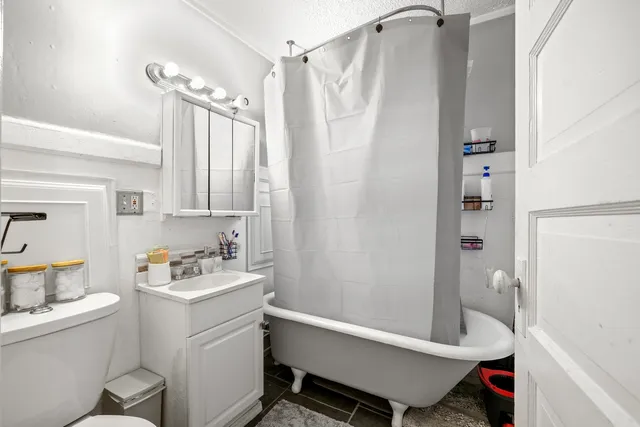 a bathroom with a sink toilet tub and shower