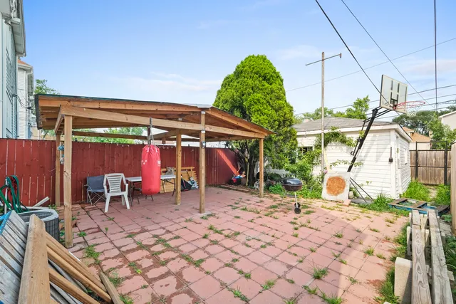 a view of a patio with a table and chairs under an umbrella