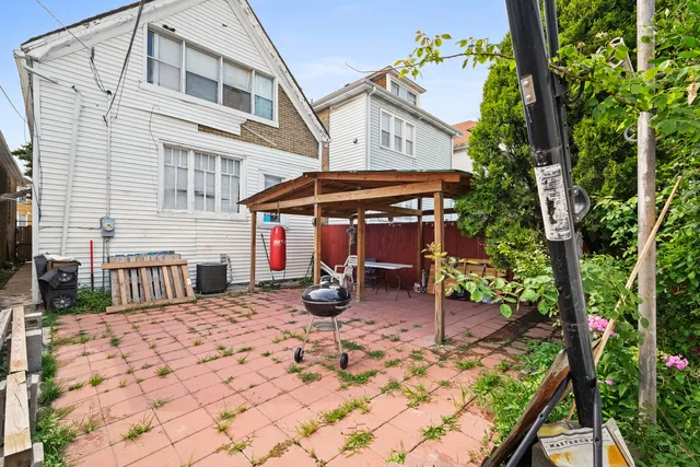 a view of a patio with a table and chairs under an umbrella