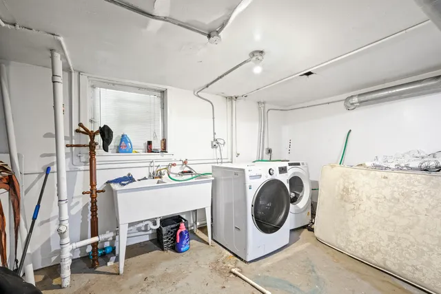 a view of a kitchen with sink washer and dryer
