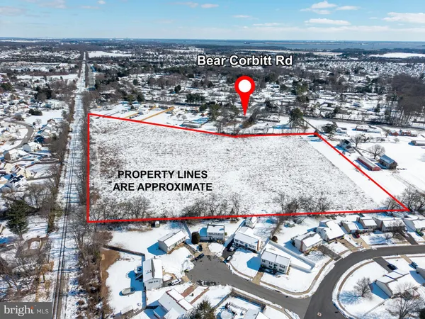 an aerial view of a beach with an outdoor space