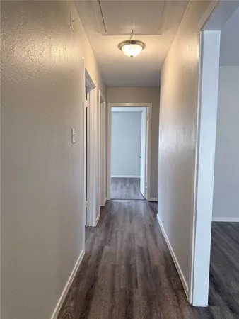 a view of hallway with wooden floor