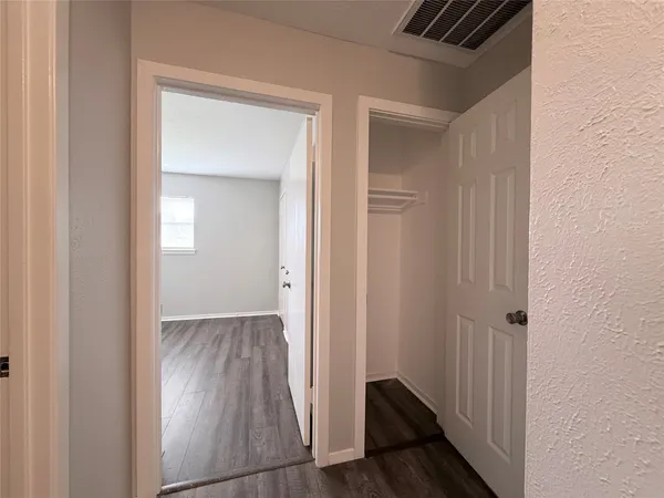 a view of hallway with wooden floor