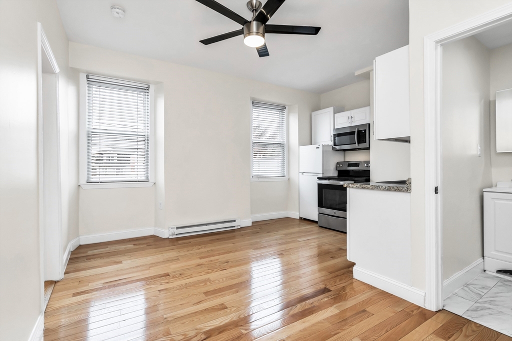 193 Appleton Street, Unit 4 Lowell, MA 01852 - Photo 11 of 21 a view of kitchen with wooden floor and electronic appliances