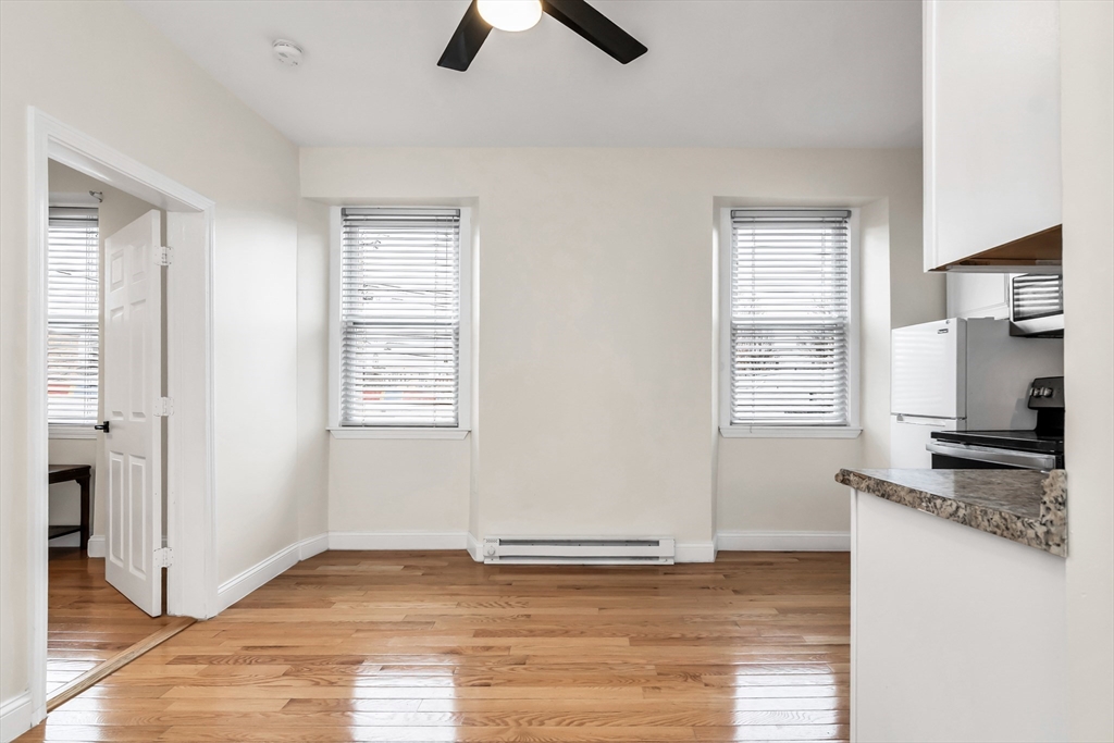 193 Appleton Street, Unit 4 Lowell, MA 01852 - Photo 12 of 21 a view of a kitchen with a sink hardwood floor and a window