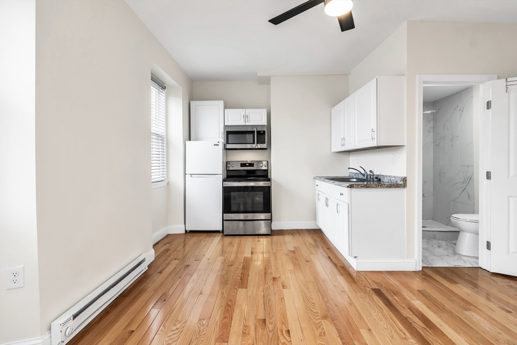 193 Appleton Street, Unit 4 Lowell, MA 01852 - Photo 13 of 21 a kitchen with wooden floors and appliances