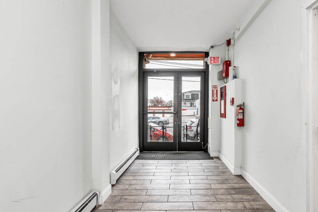 193 Appleton Street, Unit 4 Lowell, MA 01852 - Photo 7 of 21 a view of a hallway with wooden floor and entryway