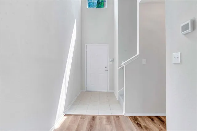 a view of a hallway with wooden floor and entryway