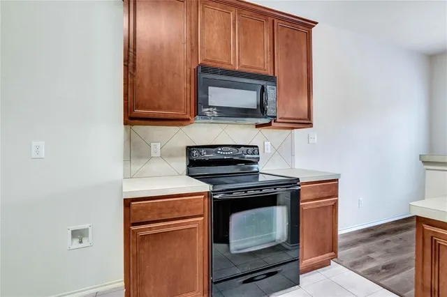 a kitchen with a stove and a microwave