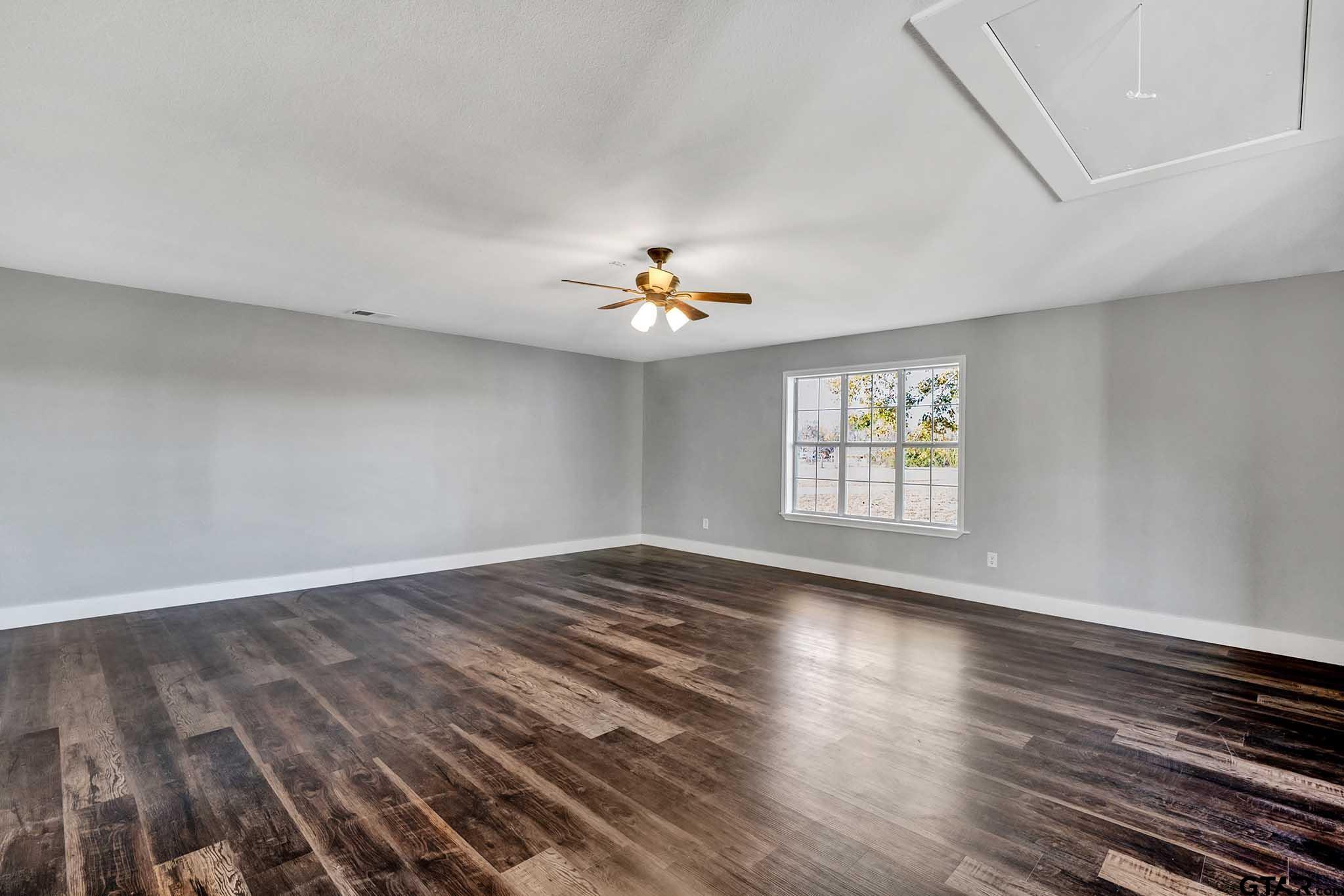 11670 Cr 345 Winona Tx 75792 Winona, TX 75792 - Photo 11 of 39 a view of an empty room with wooden floor and a window