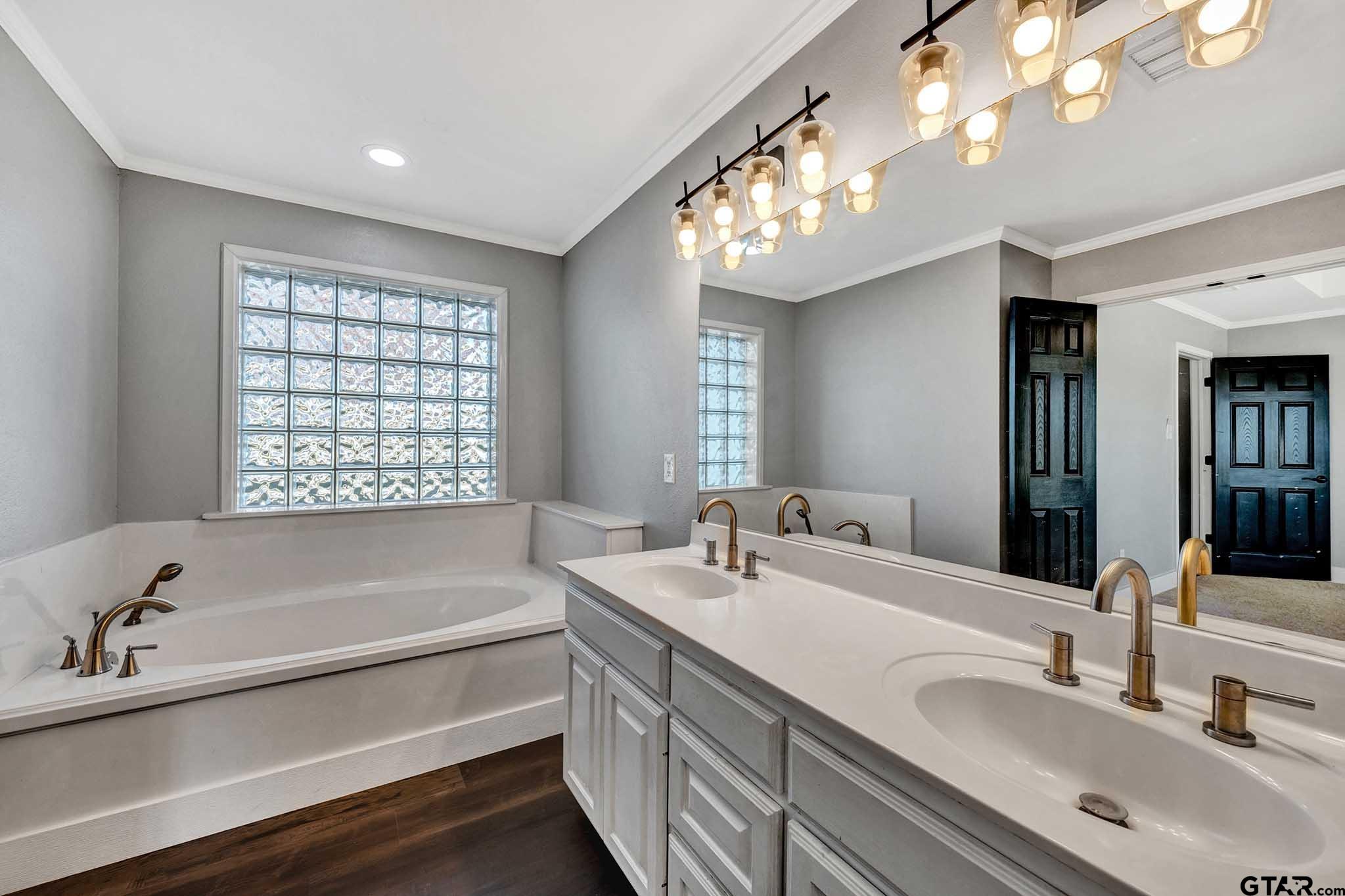 11670 Cr 345 Winona Tx 75792 Winona, TX 75792 - Photo 17 of 39 a bathroom with a bathtub a sink and a large mirror