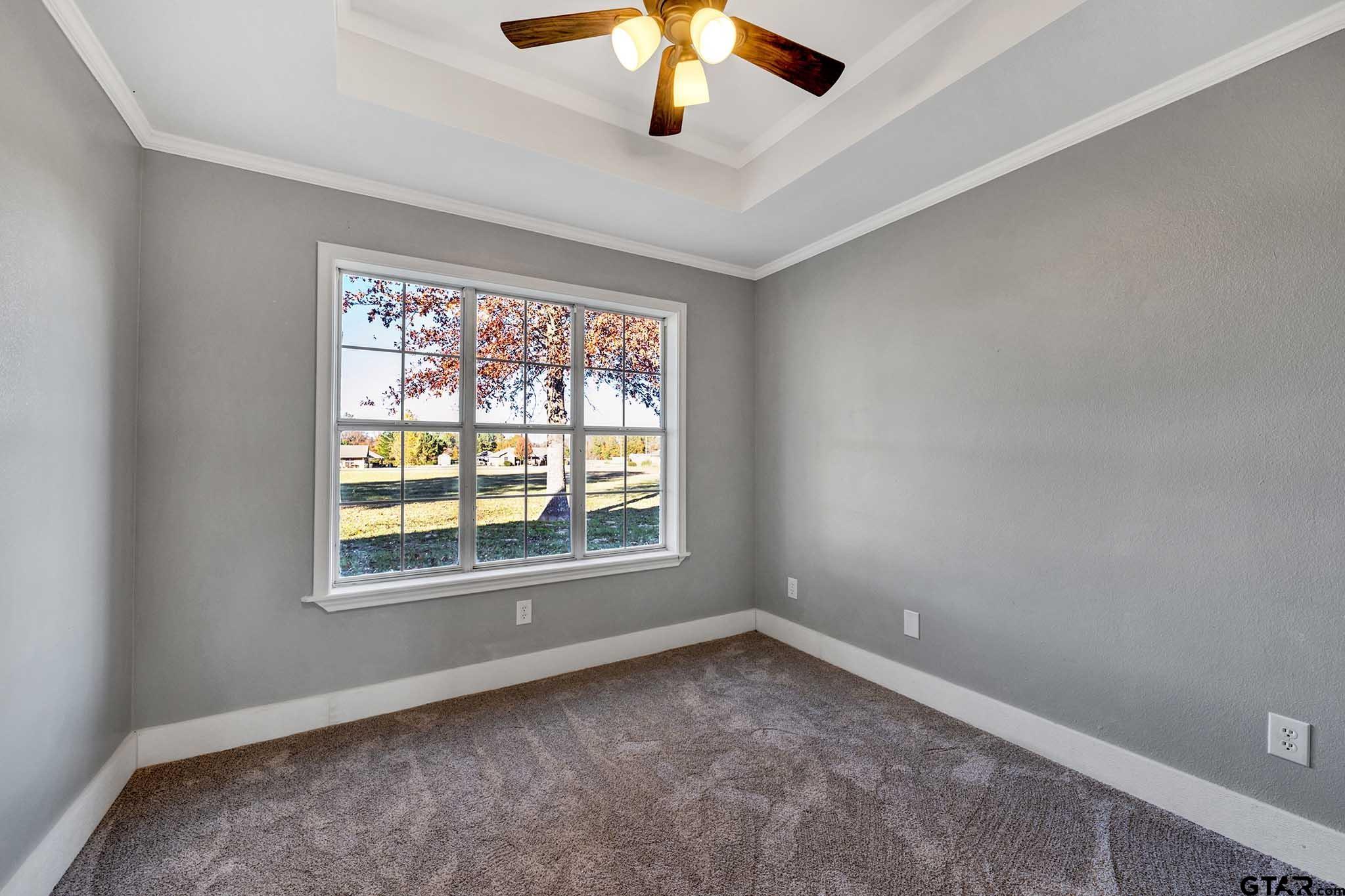 11670 Cr 345 Winona Tx 75792 Winona, TX 75792 - Photo 18 of 39 an empty room with a chandelier fan and windows