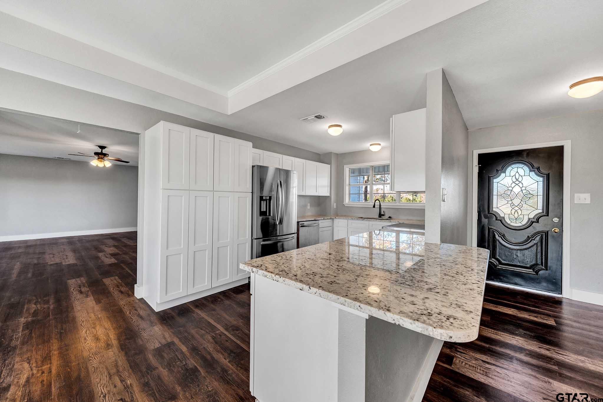 11670 Cr 345 Winona Tx 75792 Winona, TX 75792 - Photo 7 of 39 a kitchen with granite countertop kitchen island wooden floor center island and stainless steel appliances