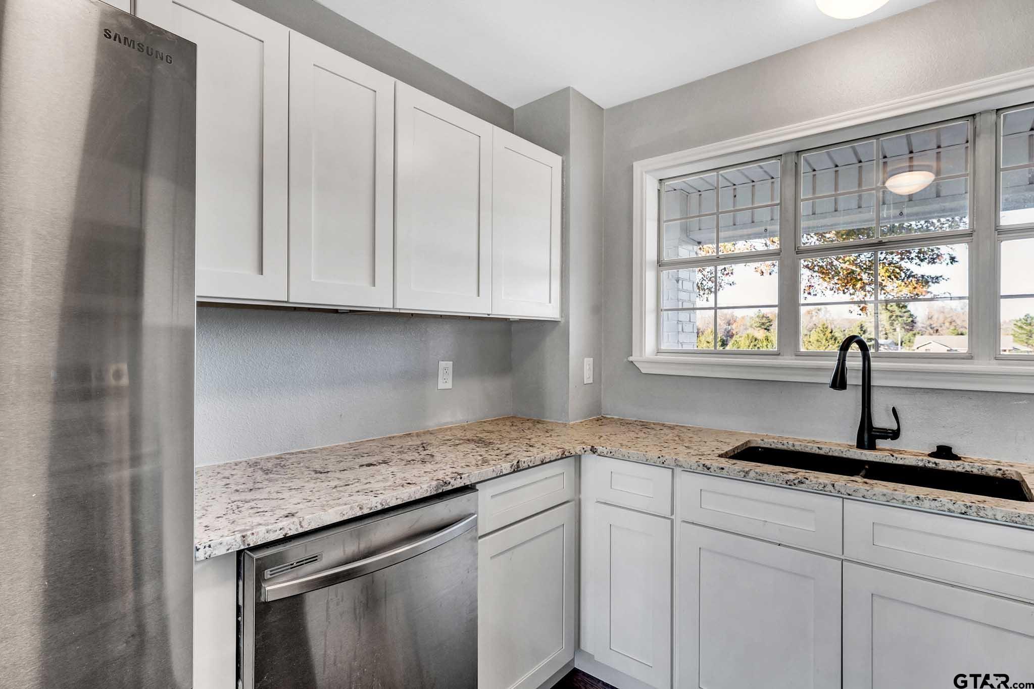 11670 Cr 345 Winona Tx 75792 Winona, TX 75792 - Photo 10 of 39 a kitchen with granite countertop white cabinets and a window