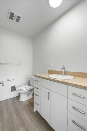 a bathroom with a toilet a sink and mirror