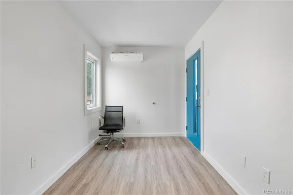 a view of room with a window and wooden floor